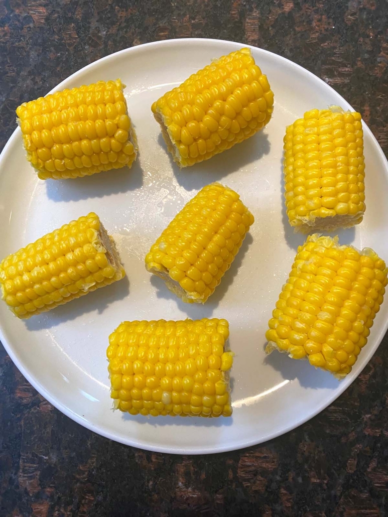 cooked corn on the cob on white plate