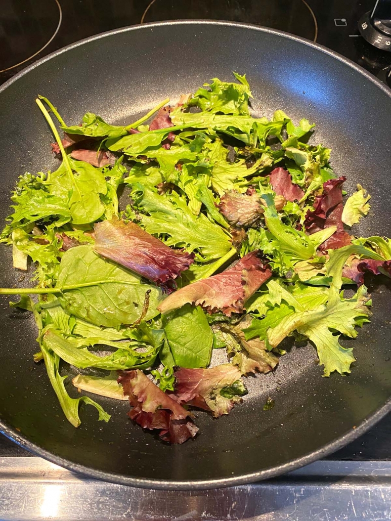 mixed lettuce in a frying pan