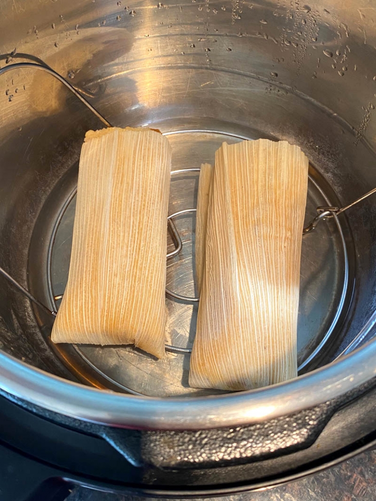 two tamales in instant pot on top of trivet