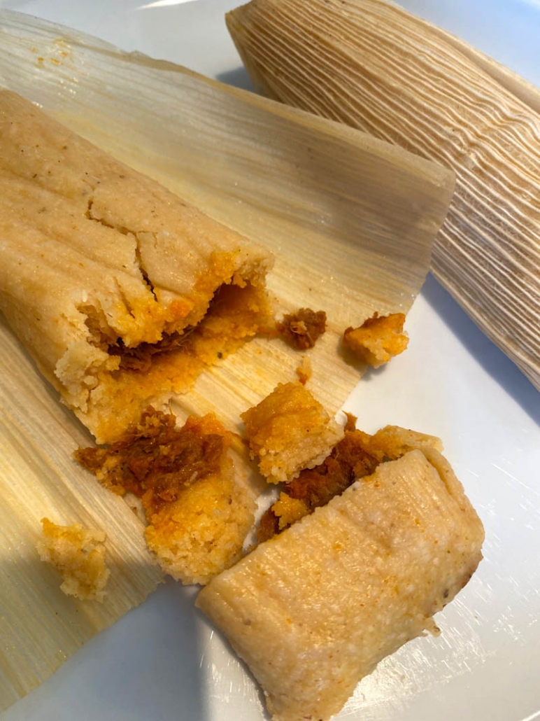 tamale cut open on a plate