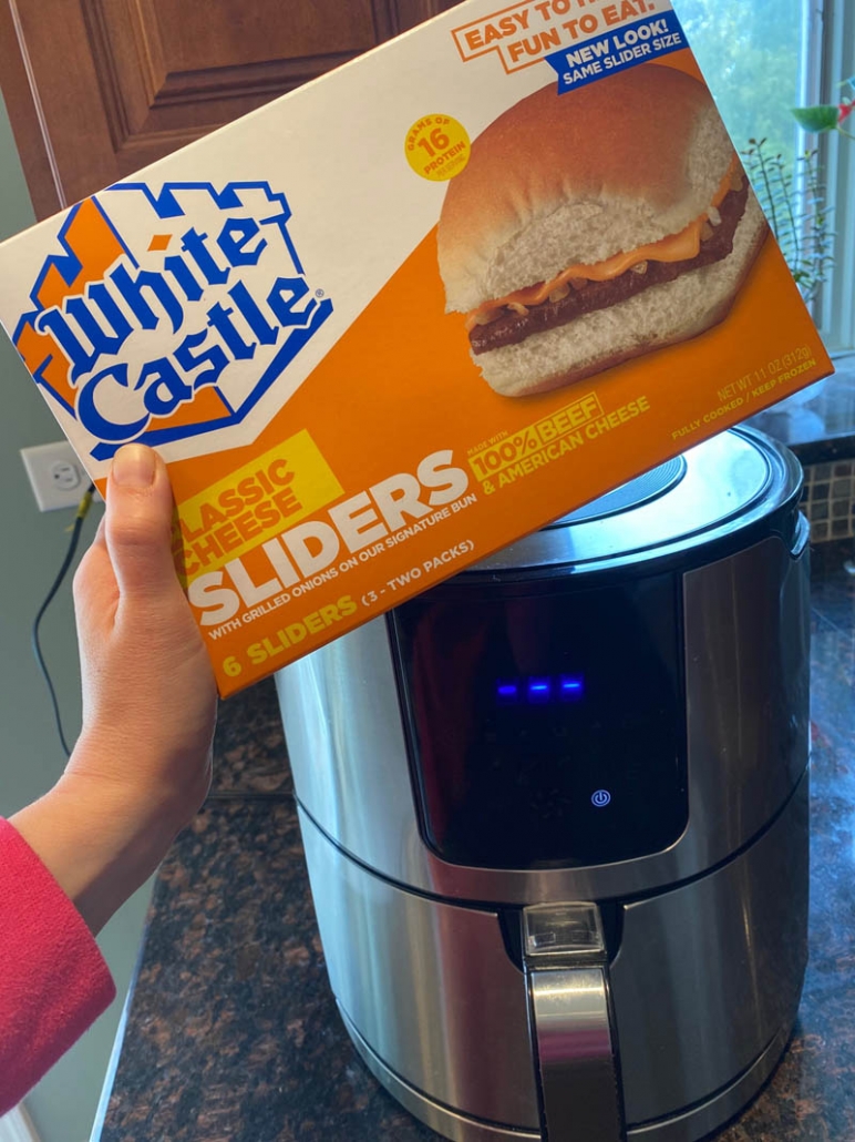 package of white castle sliders held in front of air fryer