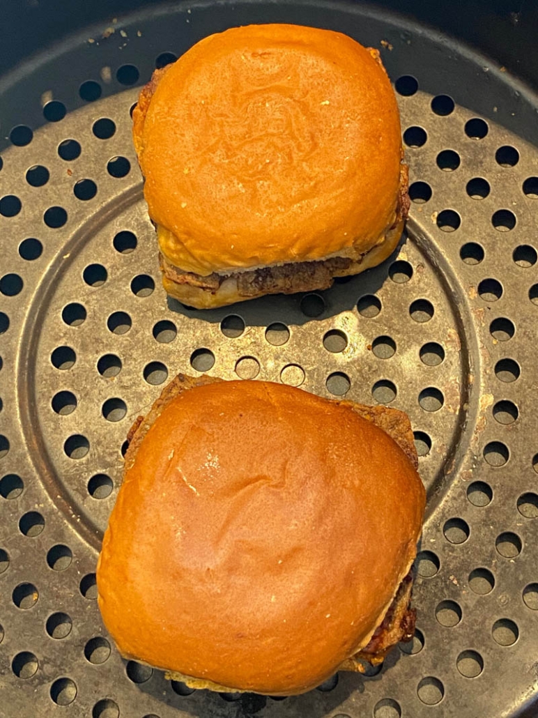 close up of two white castle sliders inside air fryer