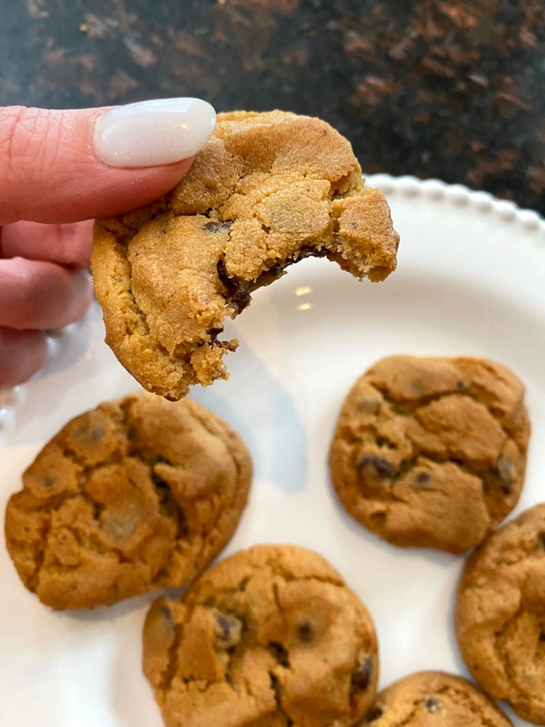 hand holding partially eaten pillsbury chocolate chip cookie cooked in air fryer