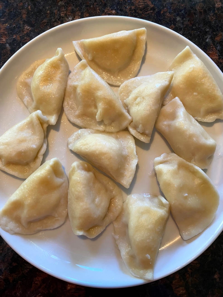 plate filled with cooked pierogies