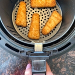 Cooked beer battered fish fillets in an air fryer.