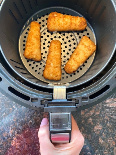 Cooked beer battered fish fillets in an air fryer.