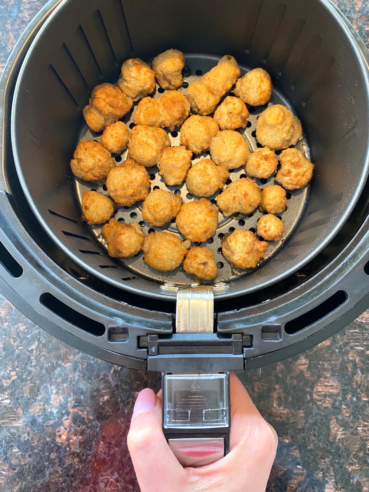 Cooked breaded mushrooms in the air fryer.