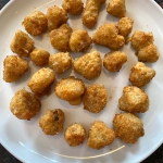 Air fried breaded mushrooms on a plate.