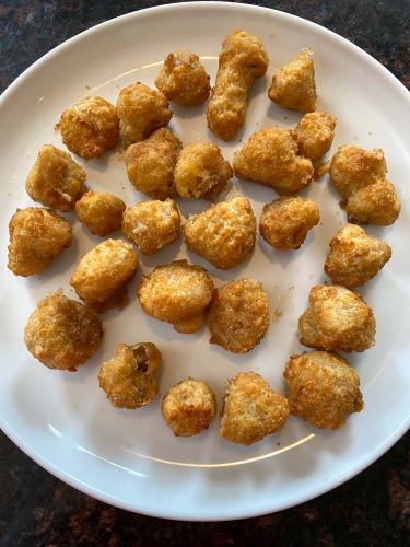 Air fried breaded mushrooms on a plate.