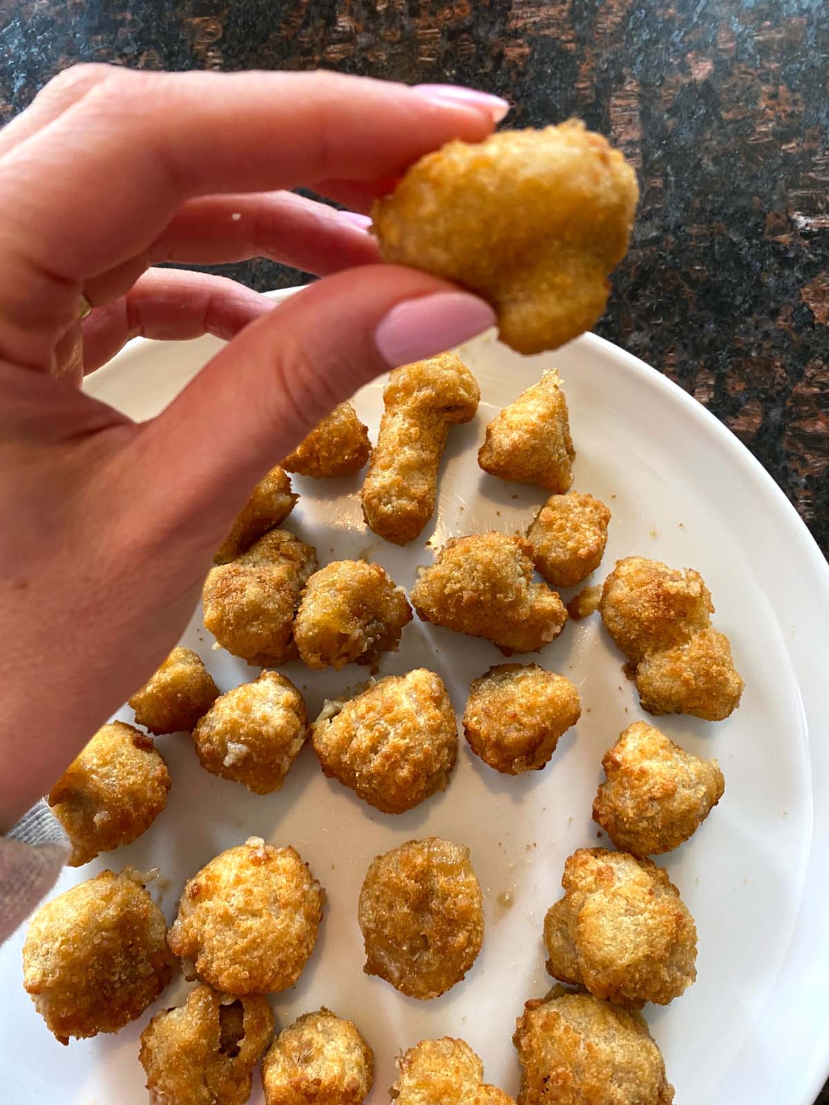 Air fried breaded mushrooms on a plate.