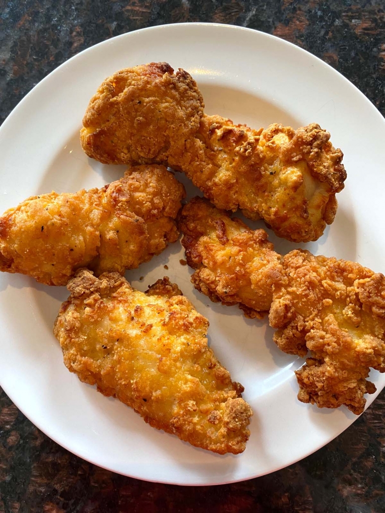 air fried chicken strips on a white plate