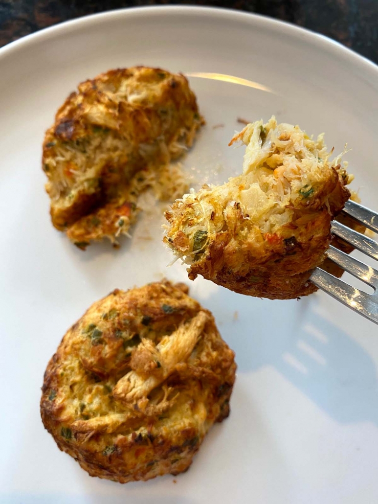 air fried crab cakes on a plate with fork holding half of one