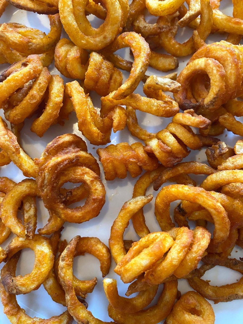 close up of air fried curly fries on a plate