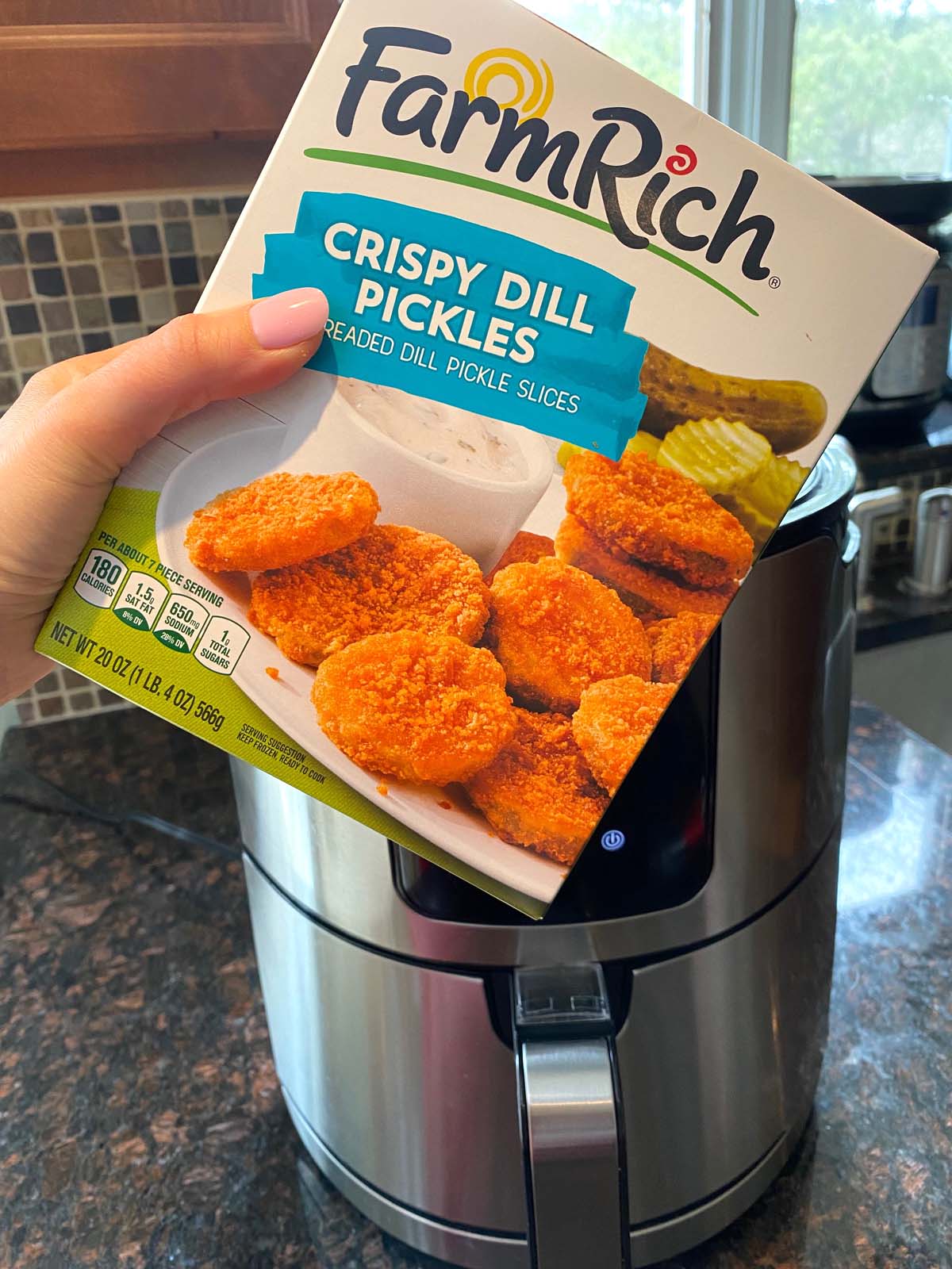 Box of Farm Fresh brand frozen fried pickles held in front of an air fryer.