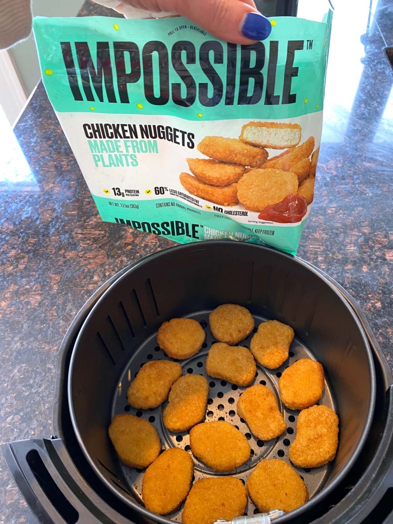 package of frozen Impossible nuggets next to cooked Impossible Chicken Nuggets In Air Fryer