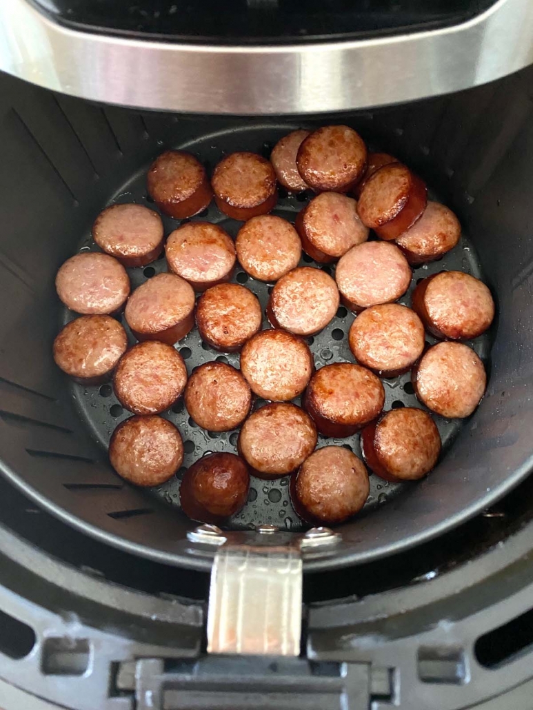 cooked kielbasa slices inside air fryer basket