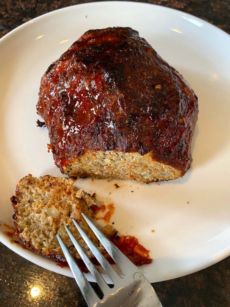 meatloaf on a plate with fork selecting a piece
