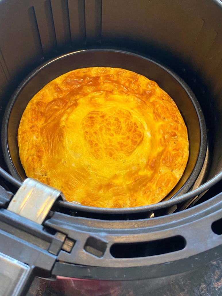 golden brown omelette inside the air fryer basket