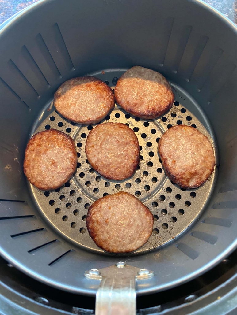 overhead shot of 6 air fried sausage patties in the air fryer basket