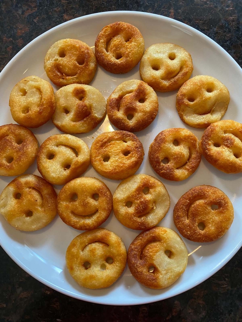 air fried smiley fries on a white plate