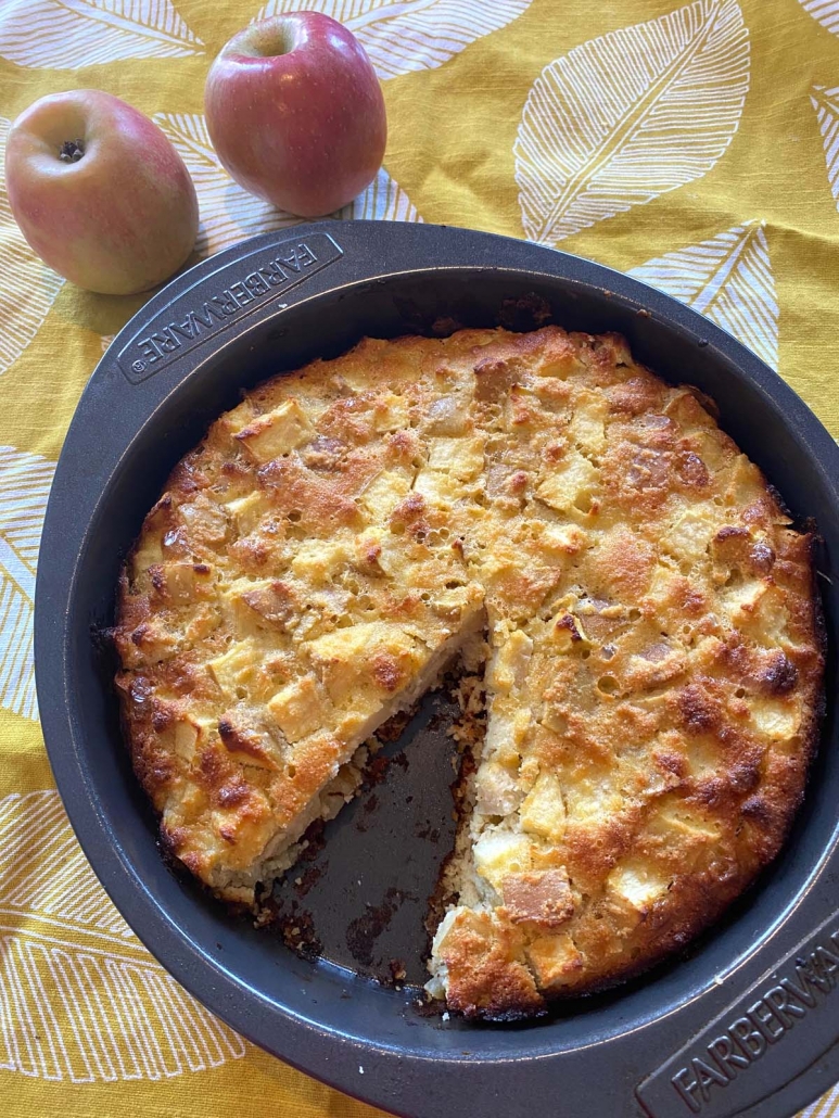 gluten free cake made with apples and almond flour with a slice removed