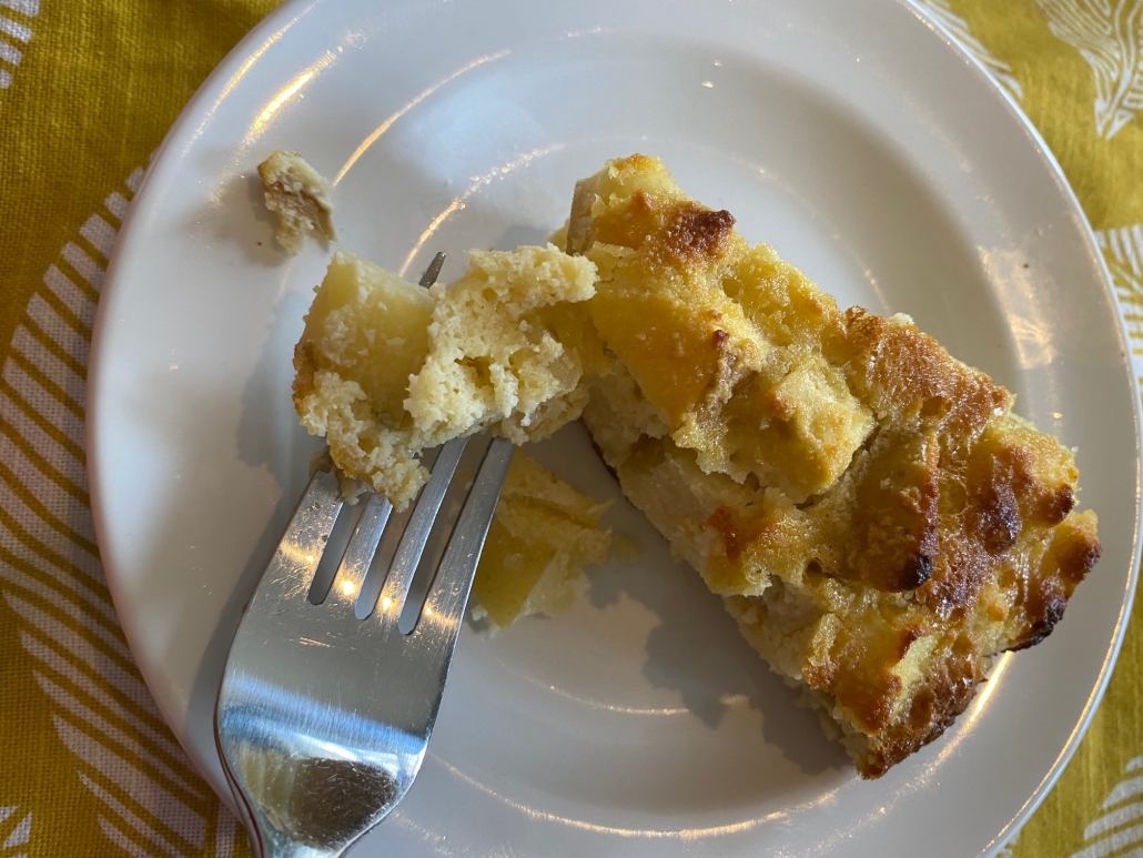 slice of apple cake with a fork picking up a bite-sized piece