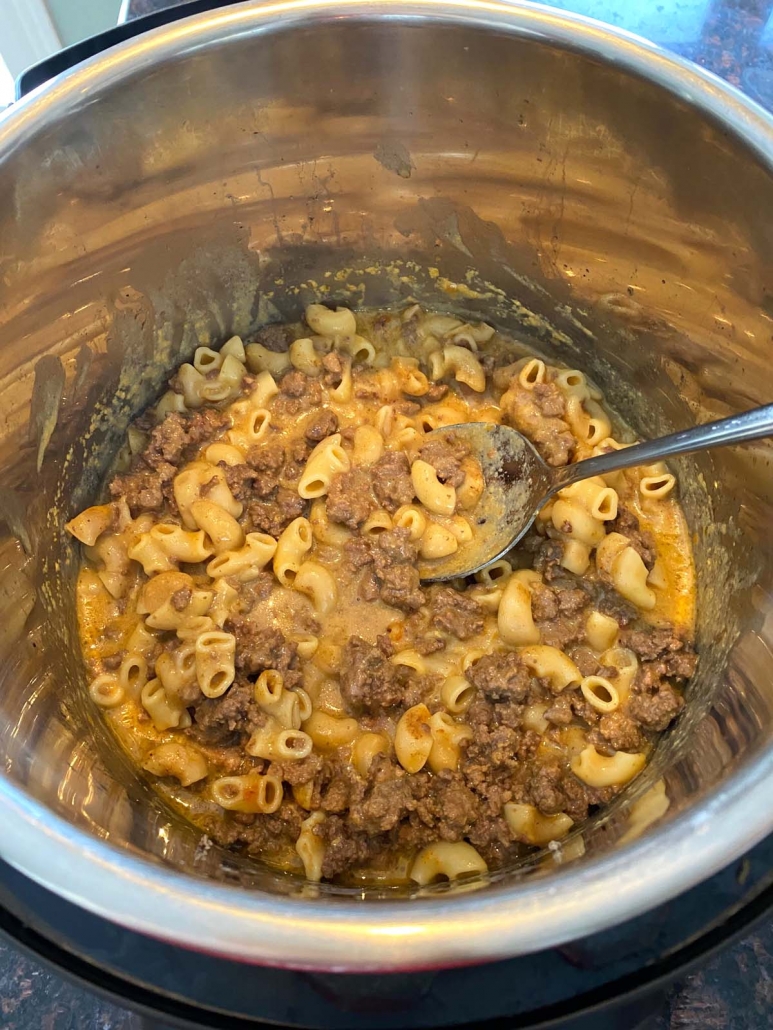 spoon inserted in hamburger helper cooking in instant pot