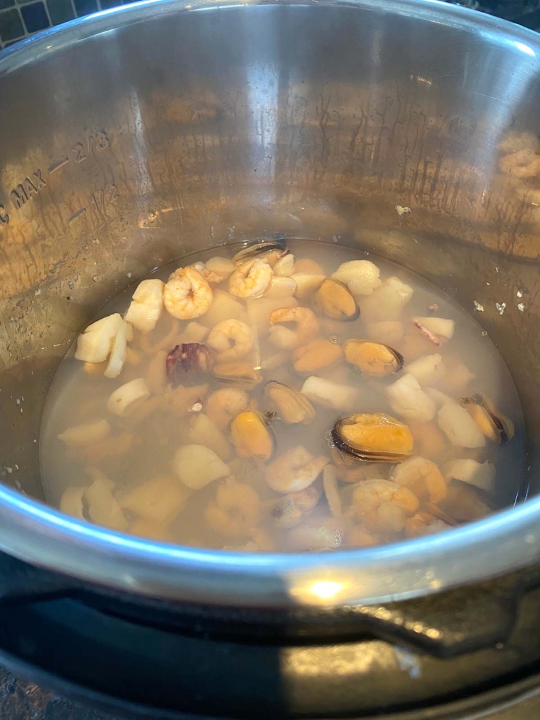 frozen seafood medley cooking in water in the instant pot