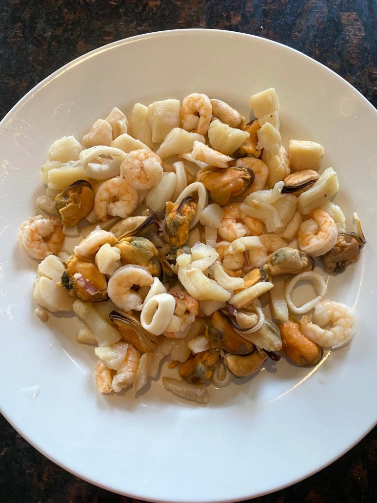 instant pot cooked seafood medley on a white plate