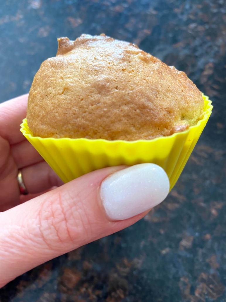 close up of hand holding muffin cooked in the air fryer
