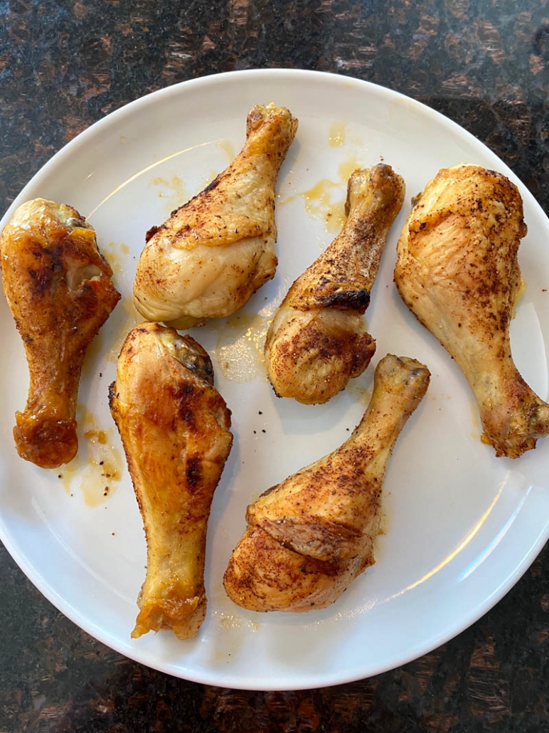 plate filled with oven baked chicken drumsticks