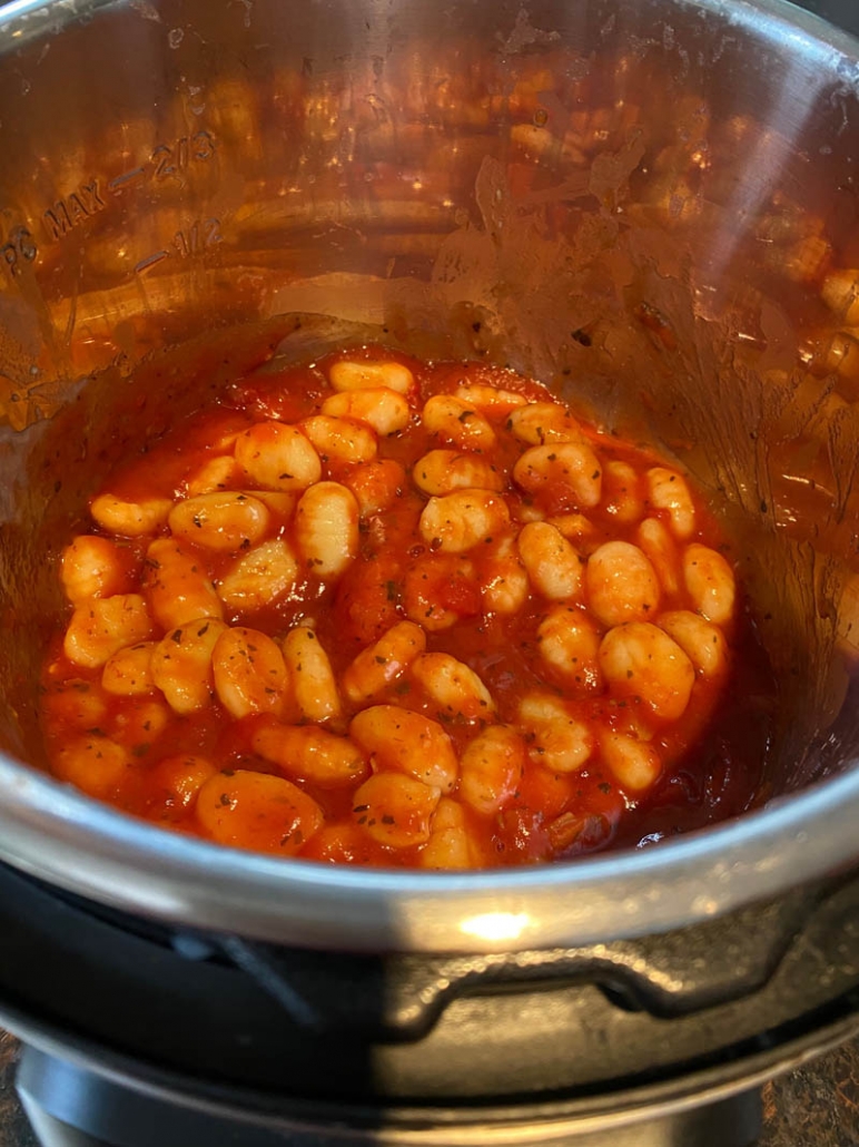 gnocchi inside instant pot covered in tomato sauce