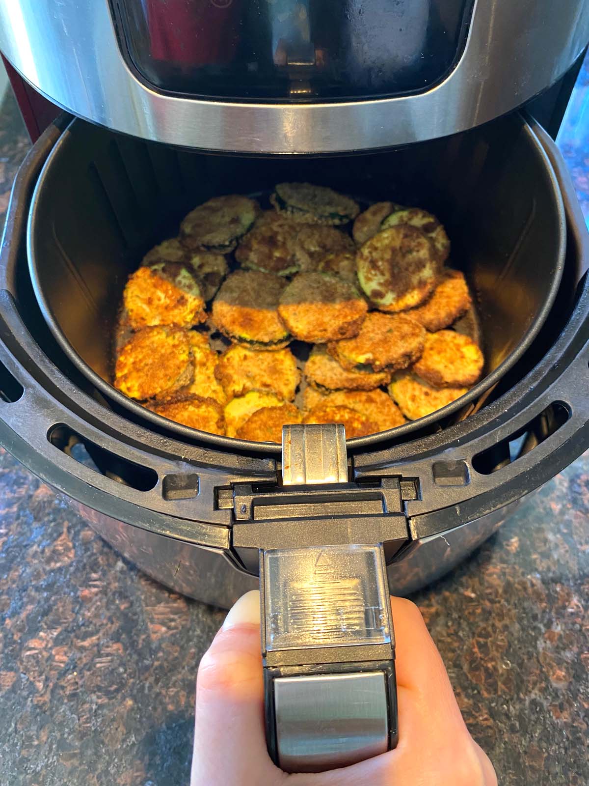 Cooked breaded zucchini in an air fryer.