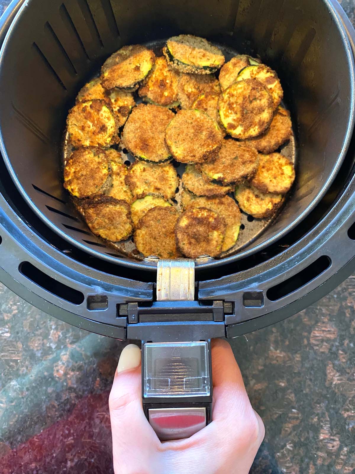 Cooked breaded zucchini in an air fryer.