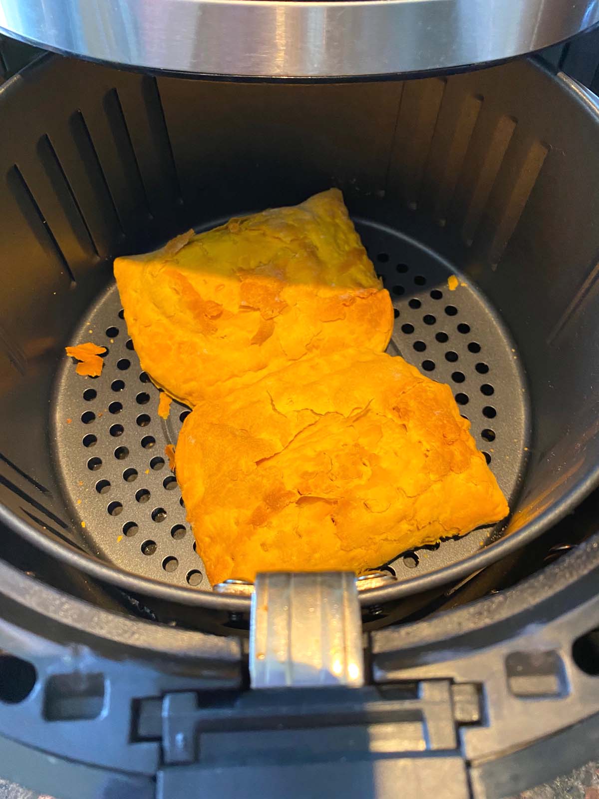 Cooked Jamaican beef patties in an air fryer.