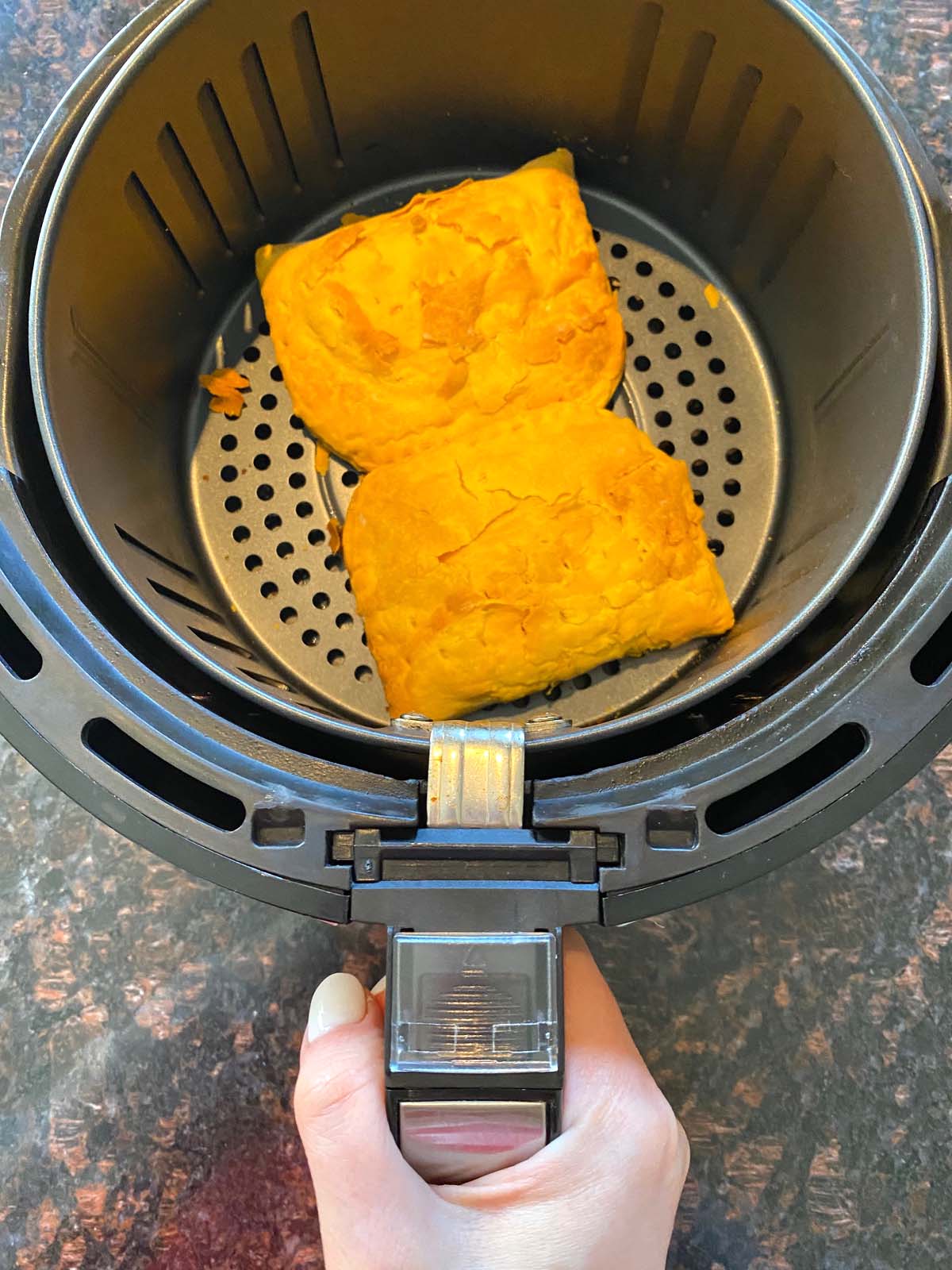 Cooked Jamaican beef patties in an air fryer.