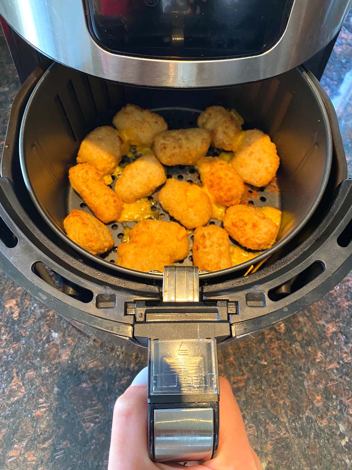 Cooked mac and cheese bites in an air fryer.