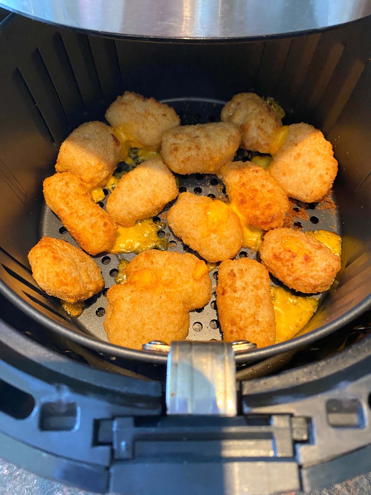 Cooked mac and cheese bites in an air fryer.