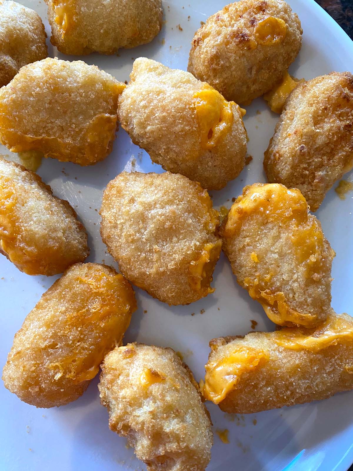 Cooked mac and cheese bites on a plate.