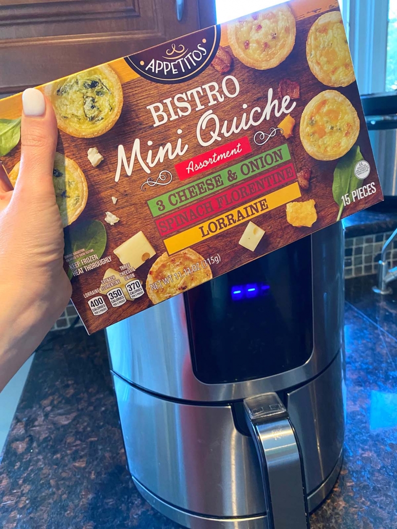 hand holding package of mini quiche in front of the air fryer