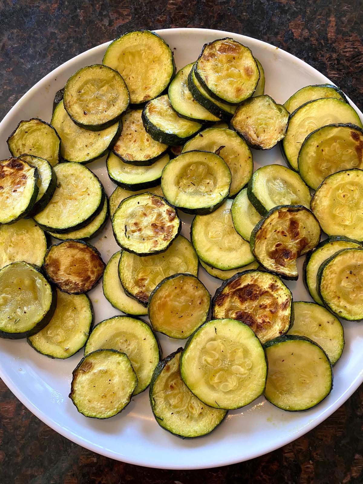 Plate of air fried roasted zucchini slices.