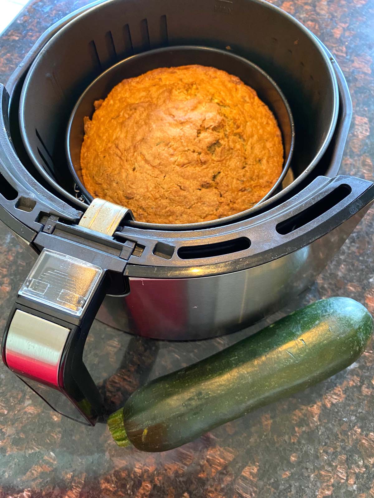 A freshly baked air fryer zucchini bread in the air fryer.