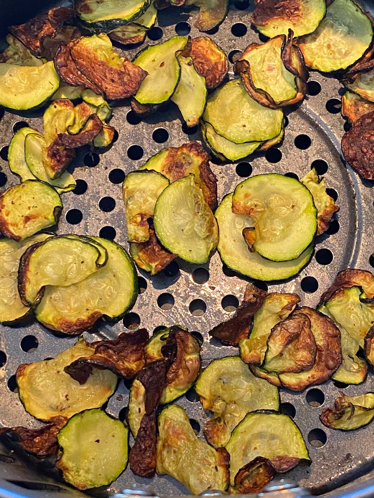 Close up of air fried zucchini chips to show texture.