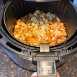 Cooked diced potatoes in an air fryer.