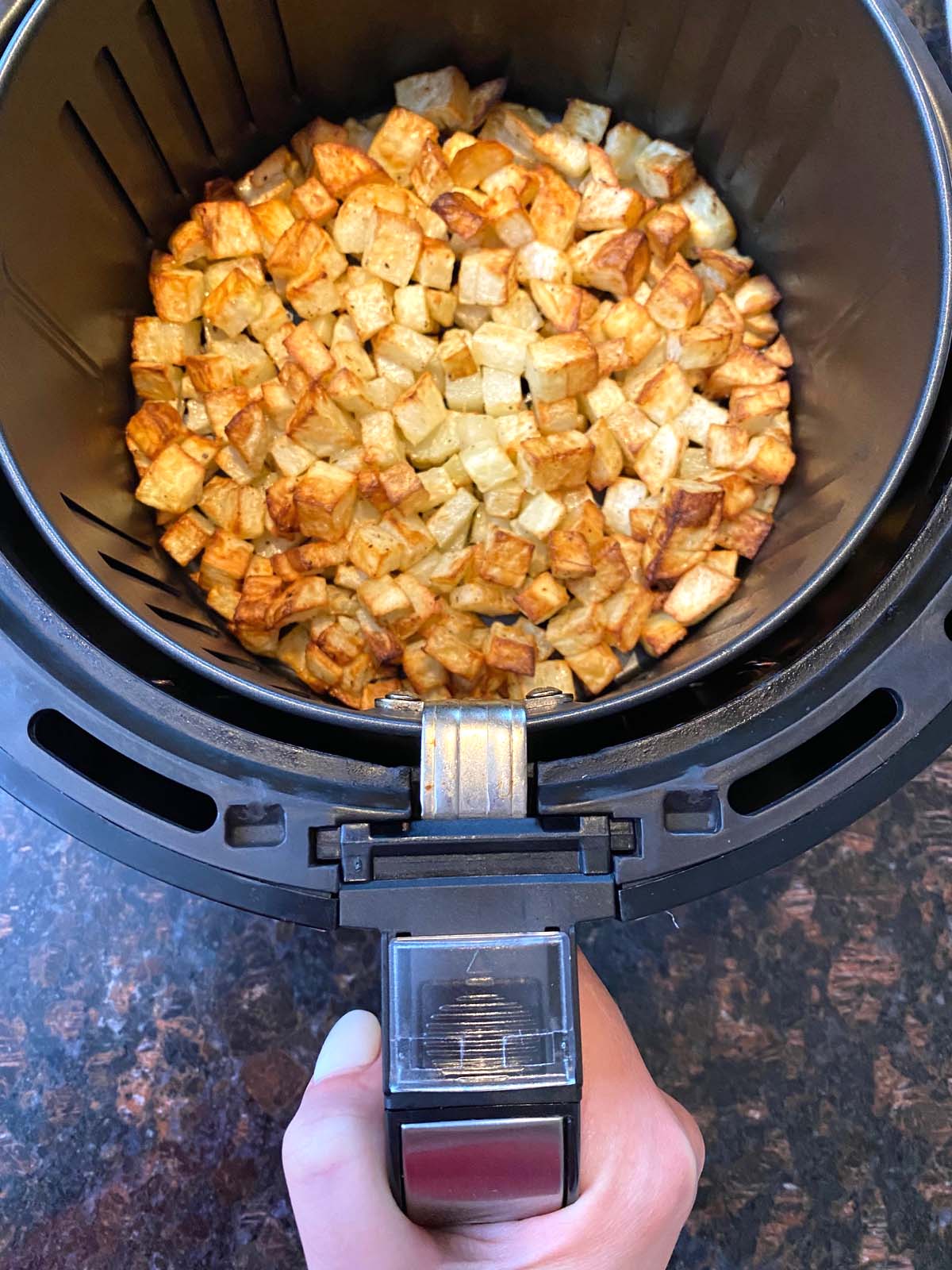 Cooked diced potatoes in an air fryer.