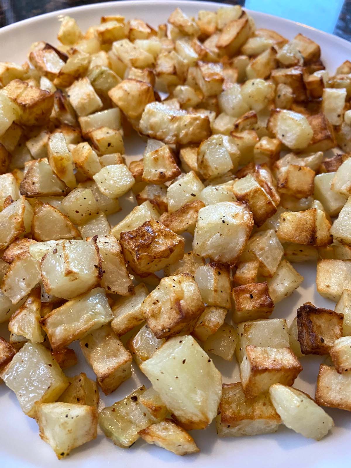 Plate of air fried diced potatoes.