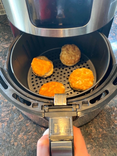 Cooked biscuits in an air fryer.