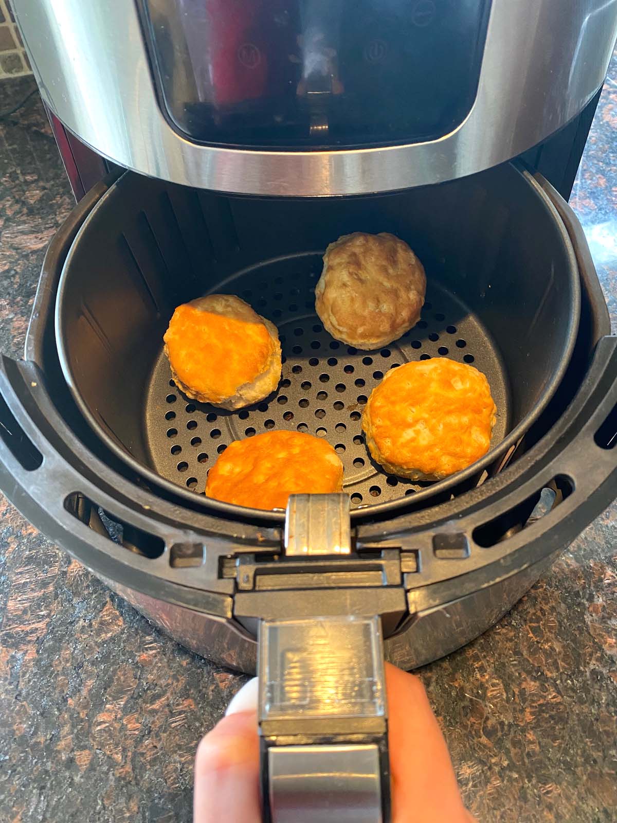 Cooked biscuits in an air fryer.