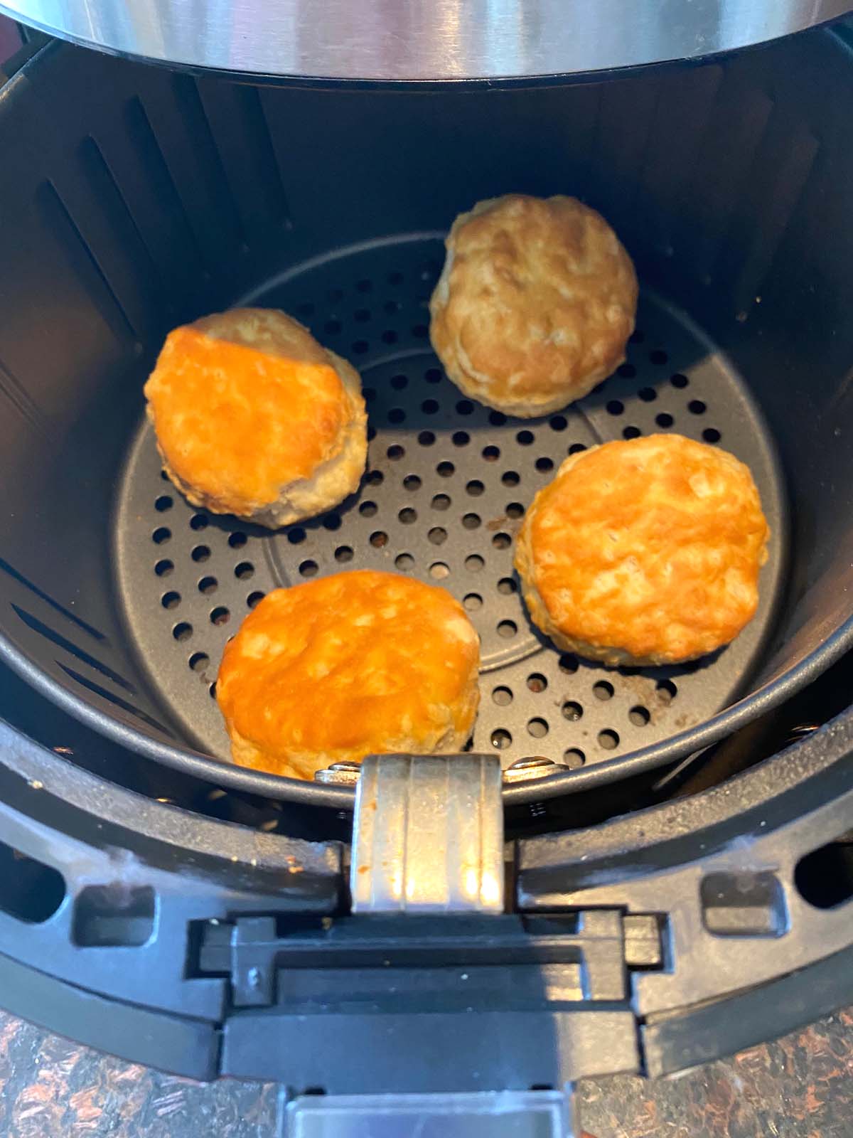 Cooked biscuits in an air fryer.
