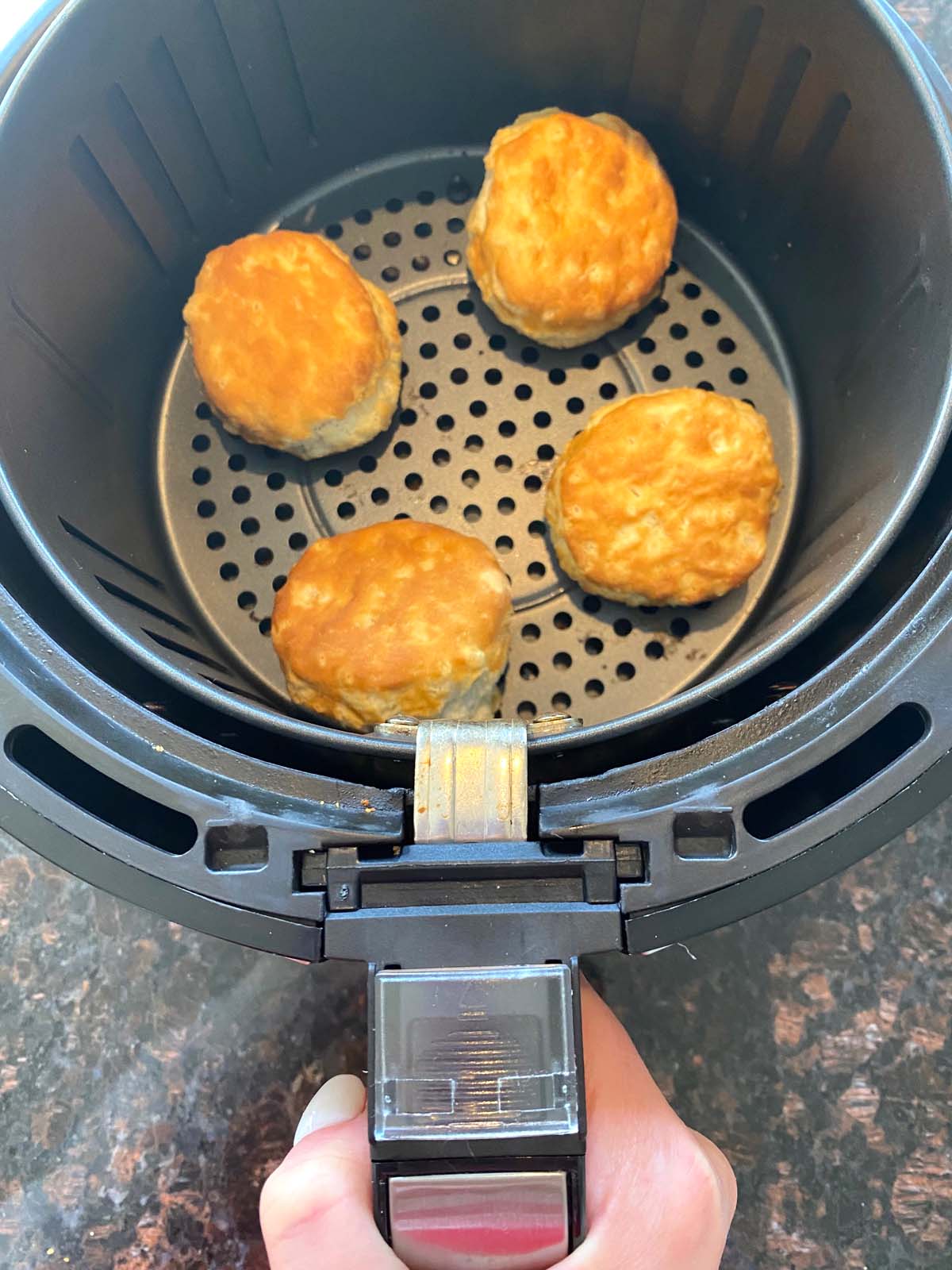 Cooked biscuits in an air fryer.